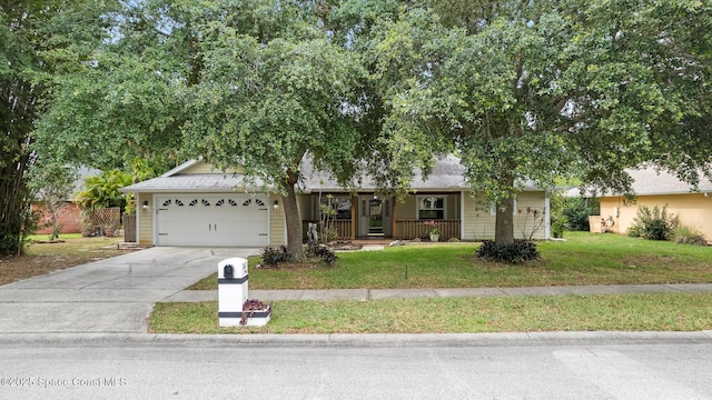 ranch-style house featuring a garage, a front lawn, driveway, a porch, and a shingled roof