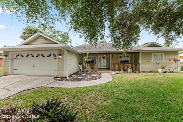 single story home featuring covered porch, an attached garage, driveway, and a front yard
