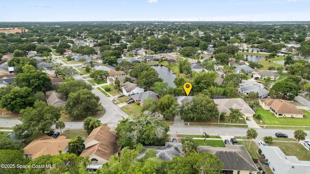 aerial view of residential area featuring a nearby body of water