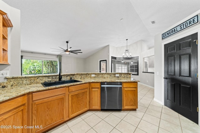 kitchen featuring stainless steel dishwasher, light tile patterned floors, a sink, lofted ceiling, and light stone counters