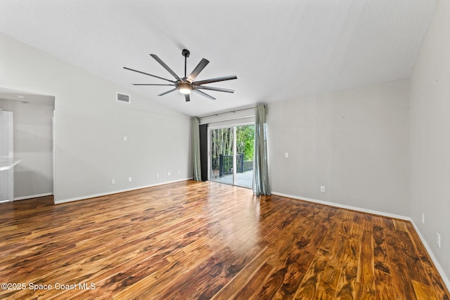 spare room featuring vaulted ceiling, ceiling fan, wood finished floors, and baseboards