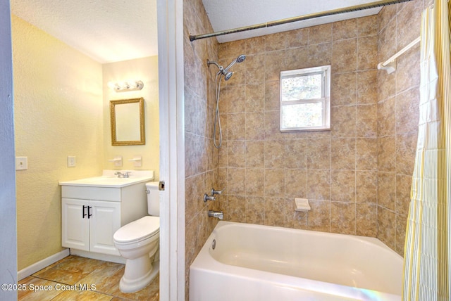 bathroom with tile patterned flooring, vanity, toilet, shower / bath combination with curtain, and baseboards