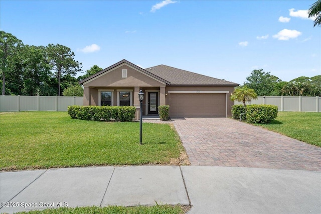 2451 Okalani St, Melbourne, FL 32940 - single story home with fence, decorative driveway, a front yard, stucco siding, and a garage