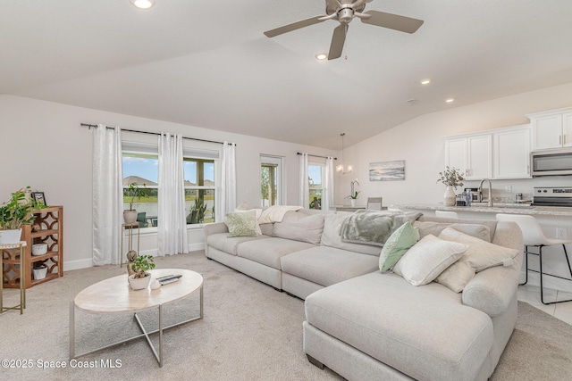 living area with a ceiling fan, recessed lighting, light colored carpet, and lofted ceiling