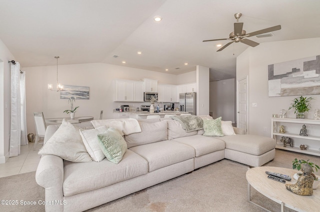 living area with light colored carpet, ceiling fan with notable chandelier, recessed lighting, light tile patterned floors, and lofted ceiling