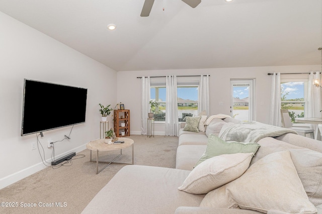 living room with baseboards, a ceiling fan, carpet flooring, and lofted ceiling