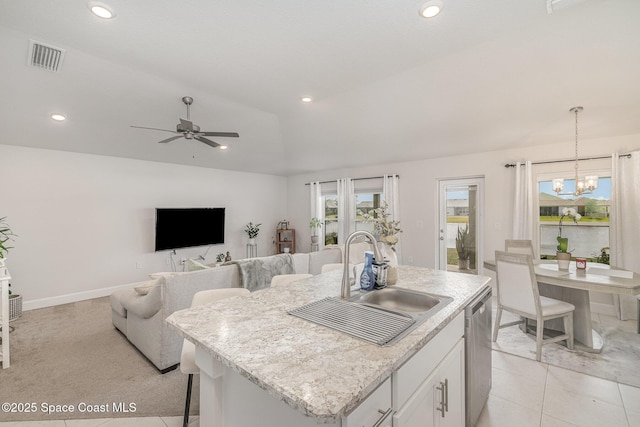 kitchen featuring stainless steel dishwasher, visible vents, a center island with sink, white cabinets, and a sink