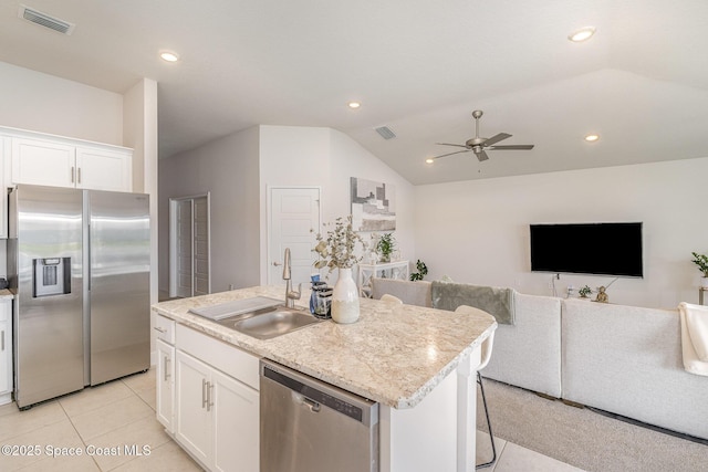 kitchen with visible vents, open floor plan, ceiling fan, a sink, and appliances with stainless steel finishes