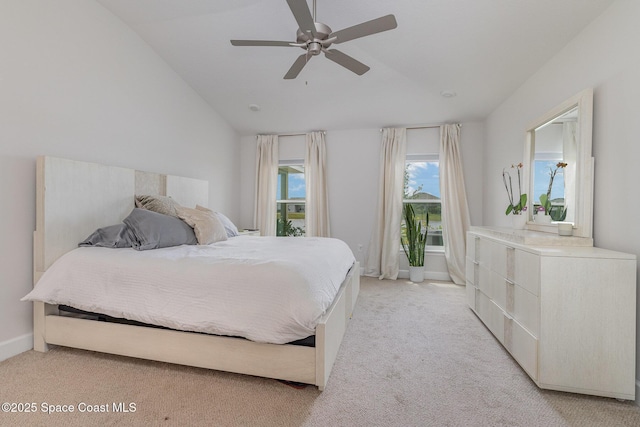bedroom with baseboards, a ceiling fan, lofted ceiling, and light carpet