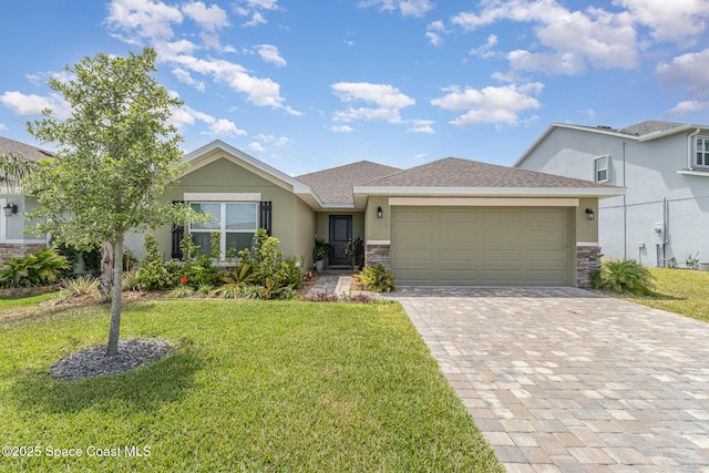 view of front of home with an attached garage, decorative driveway, a front lawn, and stucco siding