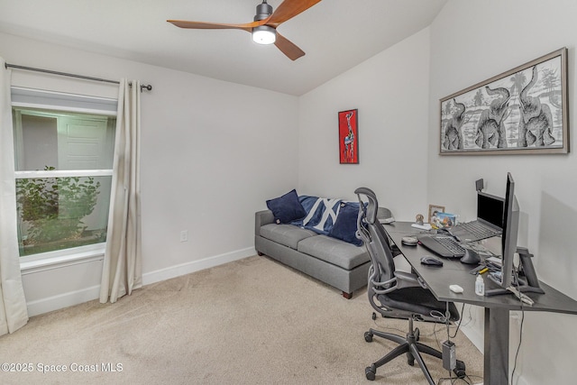 carpeted home office with ceiling fan, baseboards, and lofted ceiling