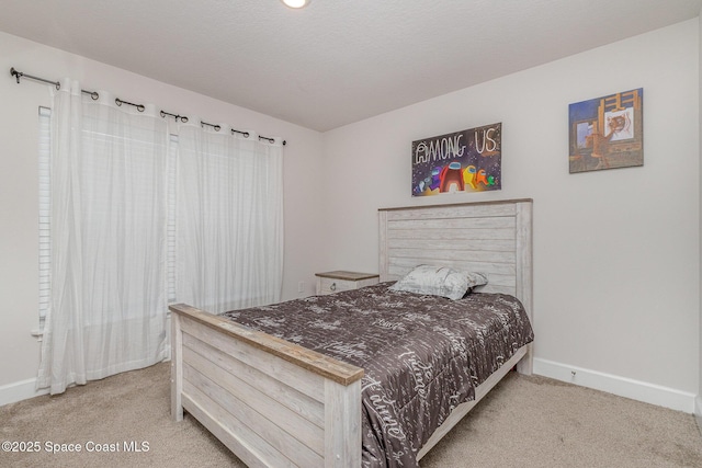 bedroom with baseboards and carpet