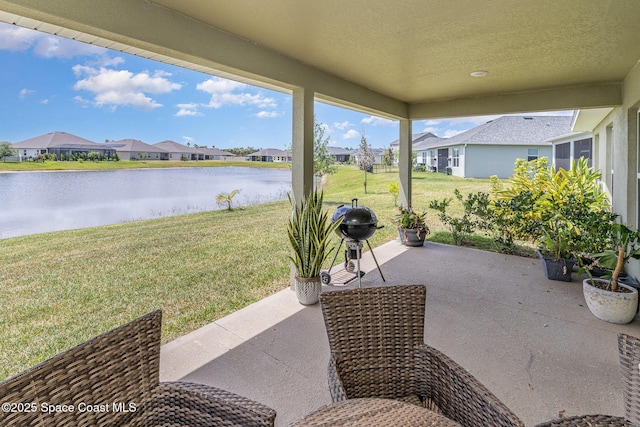 view of patio featuring a water view and a residential view