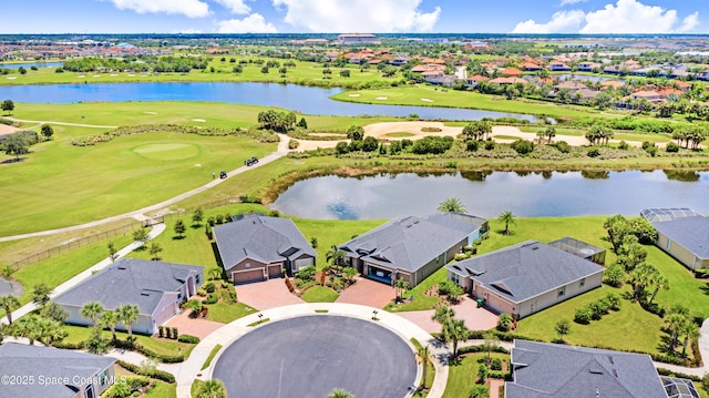birds eye view of property with a residential view, view of golf course, and a water view
