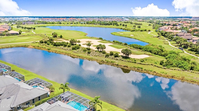 aerial view with golf course view and a water view
