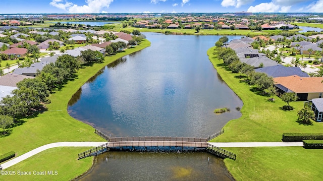 birds eye view of property with a residential view and a water view