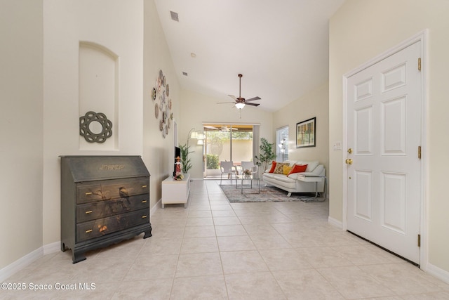 living room with light tile patterned floors, ceiling fan, high vaulted ceiling, and baseboards