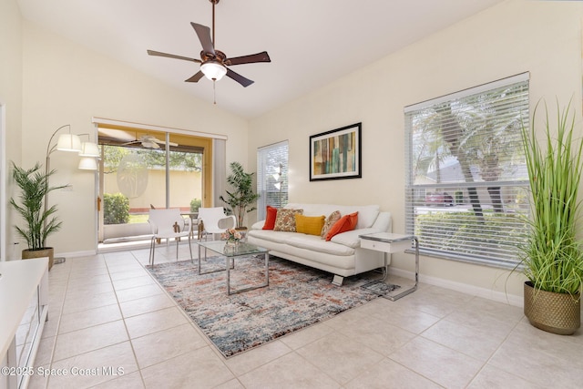 living area featuring tile patterned floors, baseboards, a ceiling fan, and lofted ceiling