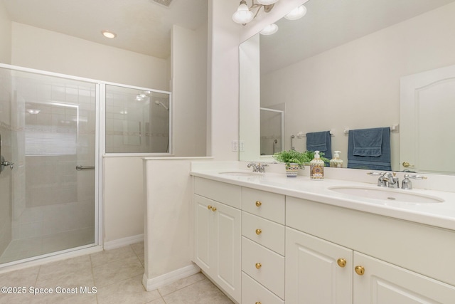 bathroom with tile patterned flooring, double vanity, a sink, and a shower stall