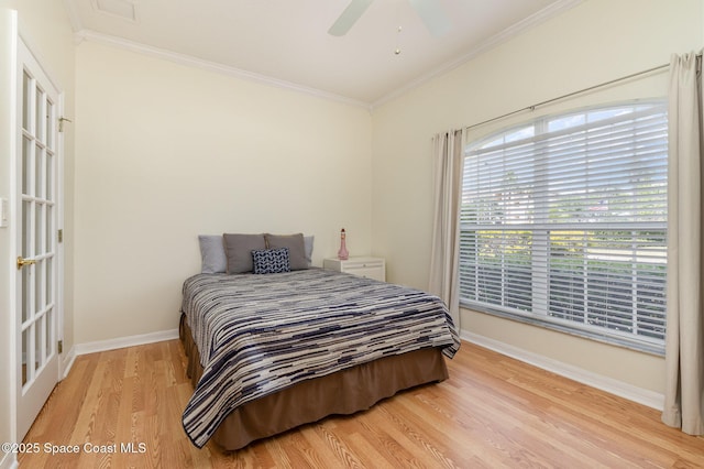 bedroom with crown molding, a ceiling fan, baseboards, and light wood-type flooring