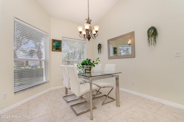 dining room with baseboards, light tile patterned floors, an inviting chandelier, and vaulted ceiling