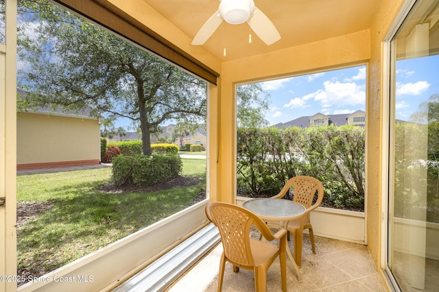 sunroom featuring ceiling fan