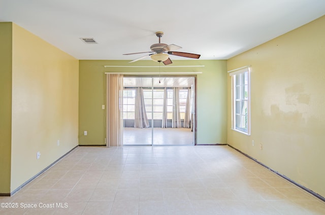 836 Brow Ct NE, Palm Bay, FL 32905 - spare room featuring a wealth of natural light, visible vents, a ceiling fan, and baseboards