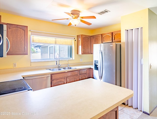 836 Brow Ct NE, Palm Bay, FL 32905 - kitchen featuring a sink, stainless steel appliances, ceiling fan, a peninsula, and light countertops