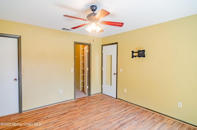 836 Brow Ct NE, Palm Bay, FL 32905 - unfurnished bedroom with visible vents, light wood-type flooring, a ceiling fan, and a closet