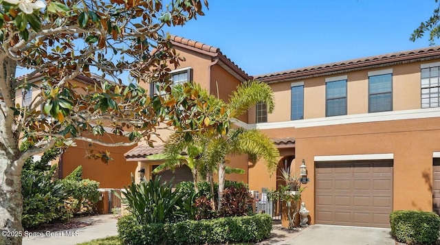 746 Ventura Dr, Satellite Beach, FL 32937 - view of front of home with stucco siding, a garage, a tiled roof, and concrete driveway