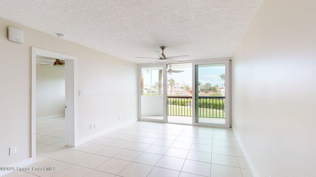 300 Columbia Dr Unit 203-2, Cape Canaveral, FL 32920 - empty room with ceiling fan, a textured ceiling, light tile patterned floors, and a smoke detector