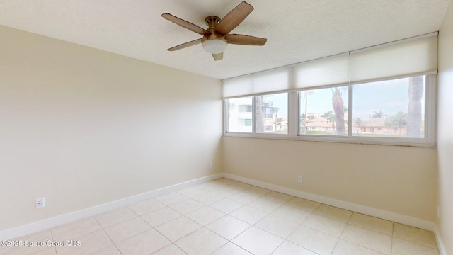 300 Columbia Dr Unit 203-2, Cape Canaveral, FL 32920 - spare room featuring ceiling fan, baseboards, and a textured ceiling