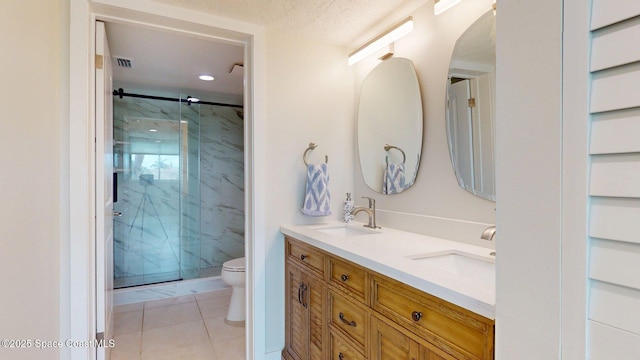 300 Columbia Dr Unit 203-2, Cape Canaveral, FL 32920 - bathroom featuring toilet, a marble finish shower, tile patterned floors, double vanity, and recessed lighting