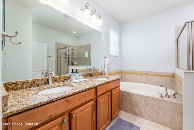 bathroom with a sink, tile patterned floors, a garden tub, and a stall shower