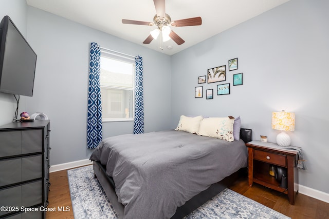 bedroom featuring baseboards, ceiling fan, and wood finished floors