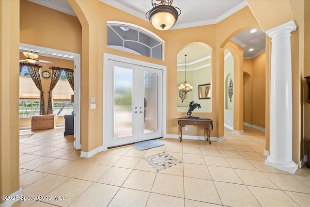 entryway featuring french doors, ornamental molding, baseboards, and light tile patterned floors
