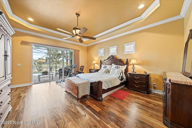 bedroom with crown molding, access to outside, and a tray ceiling