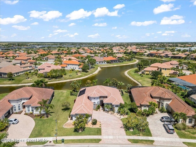 birds eye view of property featuring a water view and a residential view