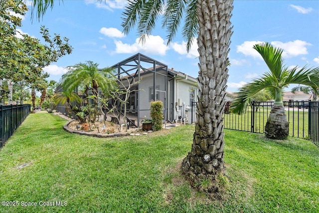 view of yard featuring a fenced backyard and glass enclosure