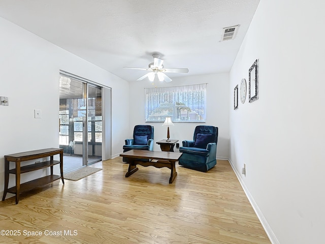 537 Ebony St, Melbourne, FL 32935 - living area with light wood-type flooring, healthy amount of natural light, and a ceiling fan