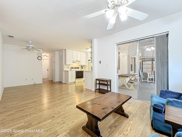 537 Ebony St, Melbourne, FL 32935 - living area featuring a ceiling fan and light wood finished floors