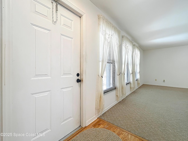 537 Ebony St, Melbourne, FL 32935 - doorway to outside with baseboards and light wood-type flooring