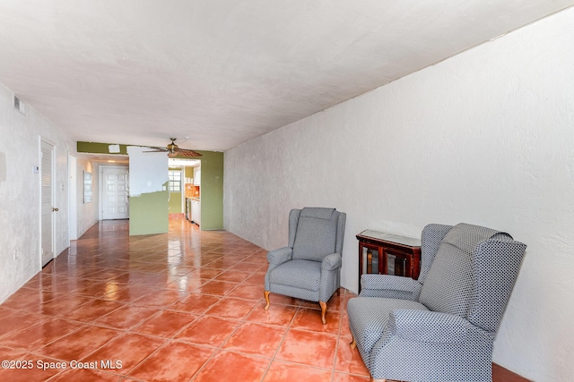 1025 Rockledge Dr Unit 502A, Rockledge, FL 32955 - sitting room featuring a ceiling fan, tile patterned floors, and a textured wall