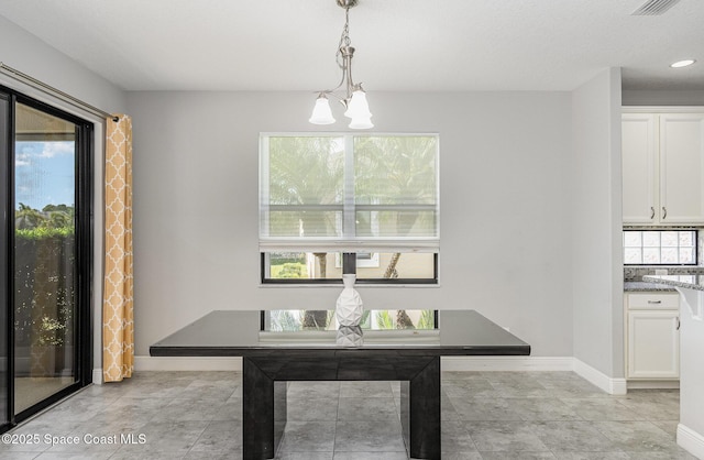 dining space with an inviting chandelier, visible vents, plenty of natural light, and baseboards