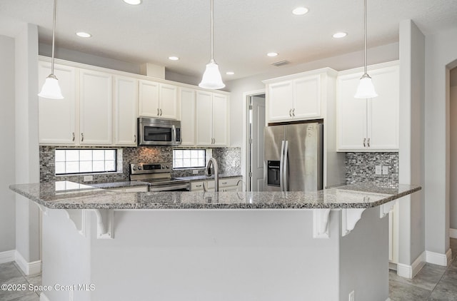 kitchen with white cabinetry, tasteful backsplash, stainless steel appliances, baseboards, and recessed lighting