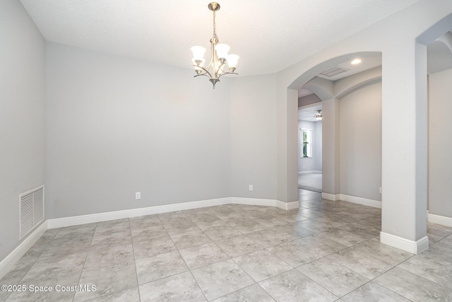 spare room with light tile patterned flooring, visible vents, baseboards, arched walkways, and ceiling fan with notable chandelier