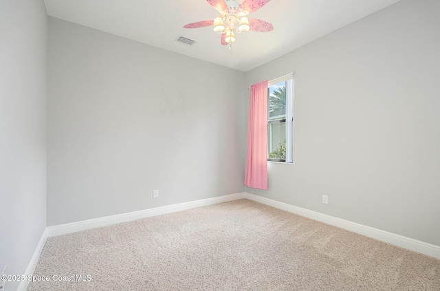 carpeted empty room featuring visible vents, ceiling fan, and baseboards