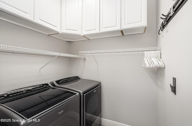 washroom featuring cabinet space and washing machine and dryer