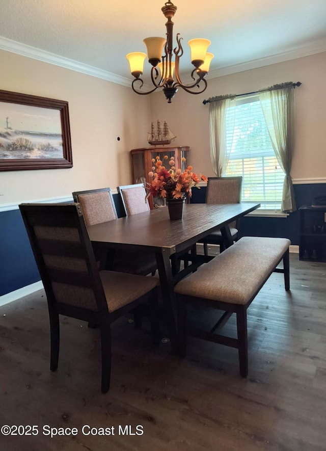 122 Morgan Cir, Sebastian, FL 32958 - dining room featuring crown molding, wood finished floors, and a chandelier