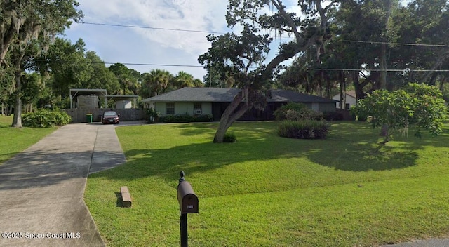 ranch-style house with concrete driveway and a front lawn
